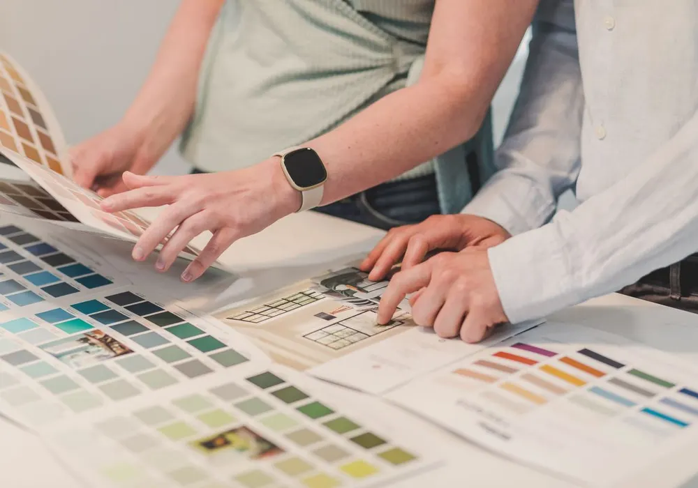Designers matching brand colours on printed swatches – Rocklink Brands design and colour proofing, Nairobi
